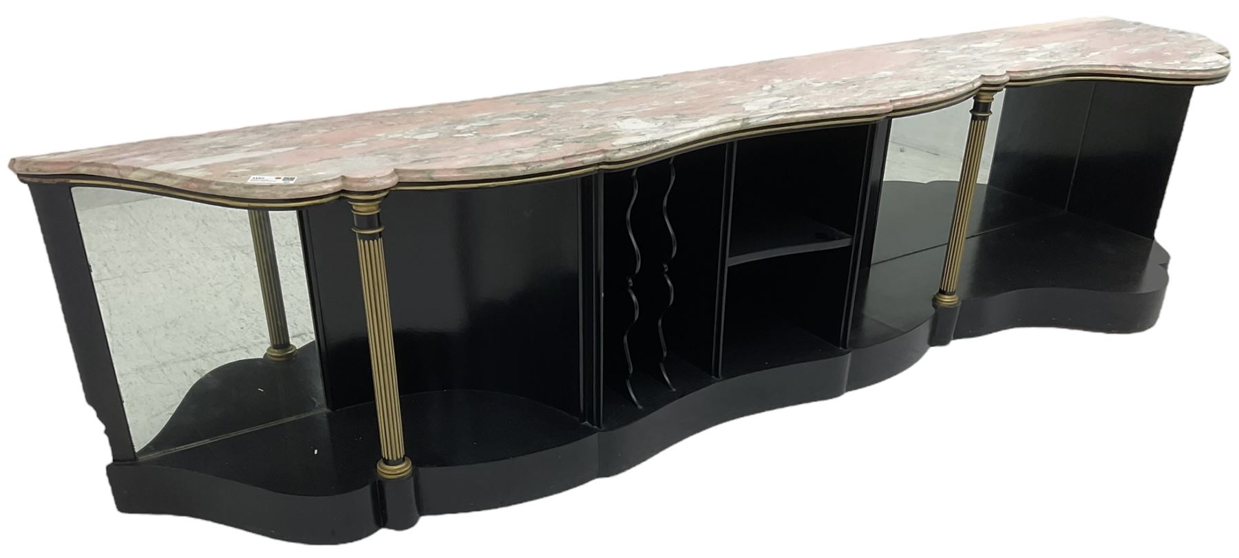 Italian ebonised and gilt serpentine corner console bookcase cabinet, shaped pink marble top over assorted shelves and dividers with fluted pilasters and mirror backs, on skirted base 