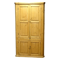  18th century country pine corner cupboard, shelved interior enclosed by four fielded panelled doors, W110cm, H194cm, D54cm  