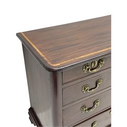 Small late 18th century mahogany chest, moulded rectangular top with rounded corners inlaid with walnut band, two short and three long graduating cock-beaded drawers with oak linings, fitted with cast brass handles and escutcheons decorated with shells and floral scrolls, lower moulding over ogee bracket feet