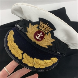 Merchant Navy captain's uniform with WW2 medal ribbons and peaked cap, epaulettes, spare cuff braiding, quantity of buttons and metal badges and two books of maritime interest