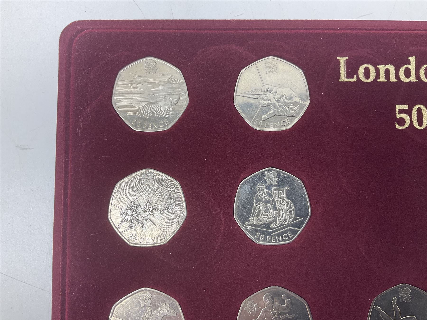 Queen Elizabeth II United Kingdom London 2012 Olympic commemorative fifty pence collection comprising twenty-nine coins and completer medallion, housed in unofficial display case