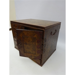  Japanese Meiji period parquetry table top cabinet, four black lacquer lined graduated drawers, fielded panelled door enclosing two further drawers, foliate engraved mounts, H27cm, W33cm x D24cm   