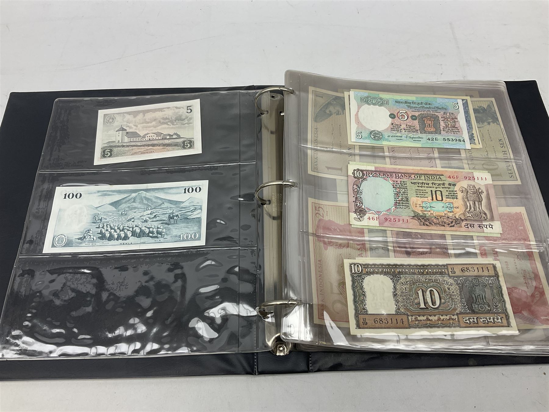 World banknotes, including Queen Elizabeth II The States of Jersey one pound 'DB202703', five pounds 'BB527762' and ten pounds 'AB651481', reserve bank of New Zealand two dollars '1L3 741894', King George V Straits Settlements one dollar 1st January 1935 'F/83 28924', various Bank of England notes etc, housed in two ring binder albums