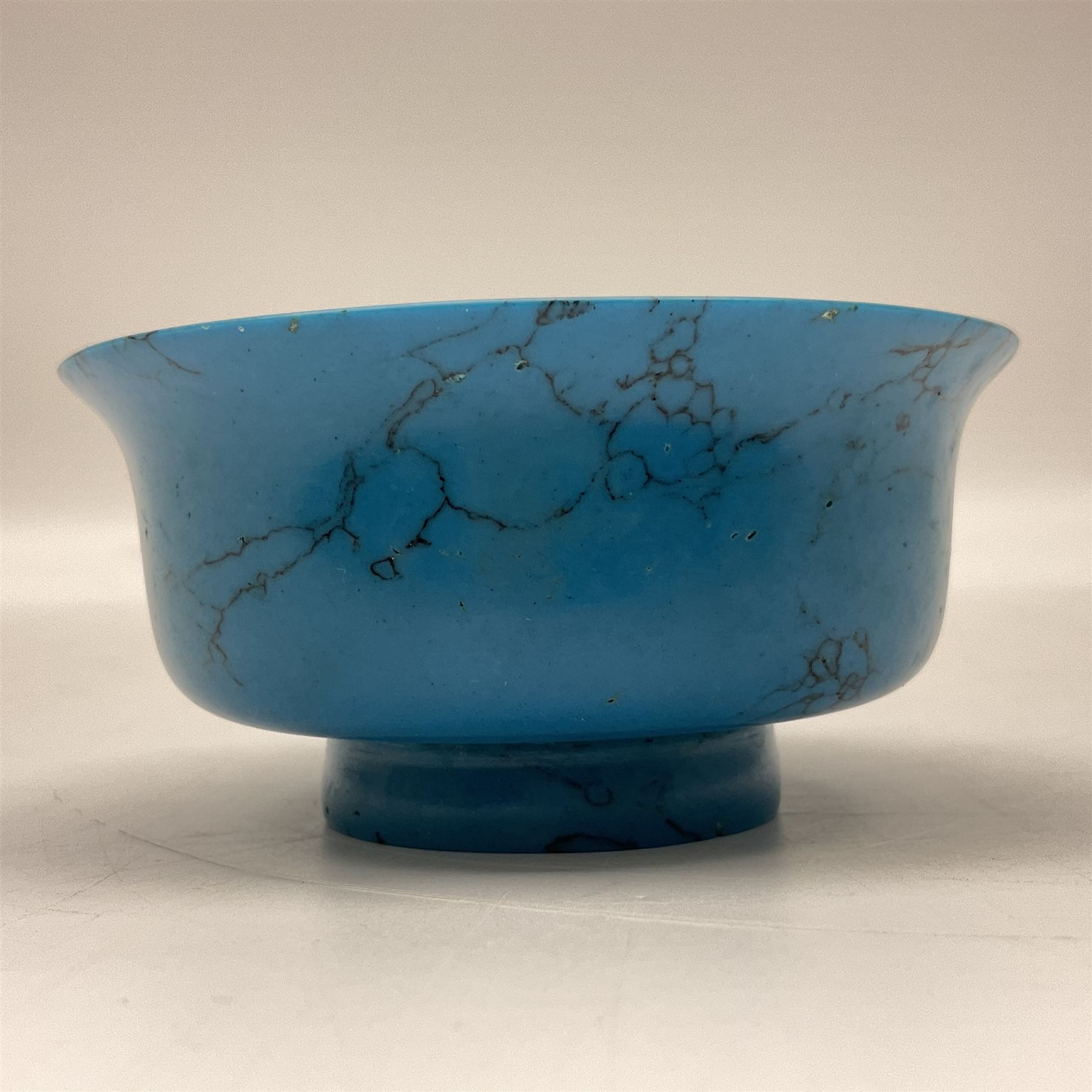 Carved single piece turquoise bowl with fluted rim, upon a raised footed base, D10cm, H5cm