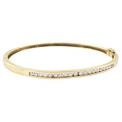 9ct gold diamond hinged bangle, channel set with twenty round brilliant cut diamonds, stam...