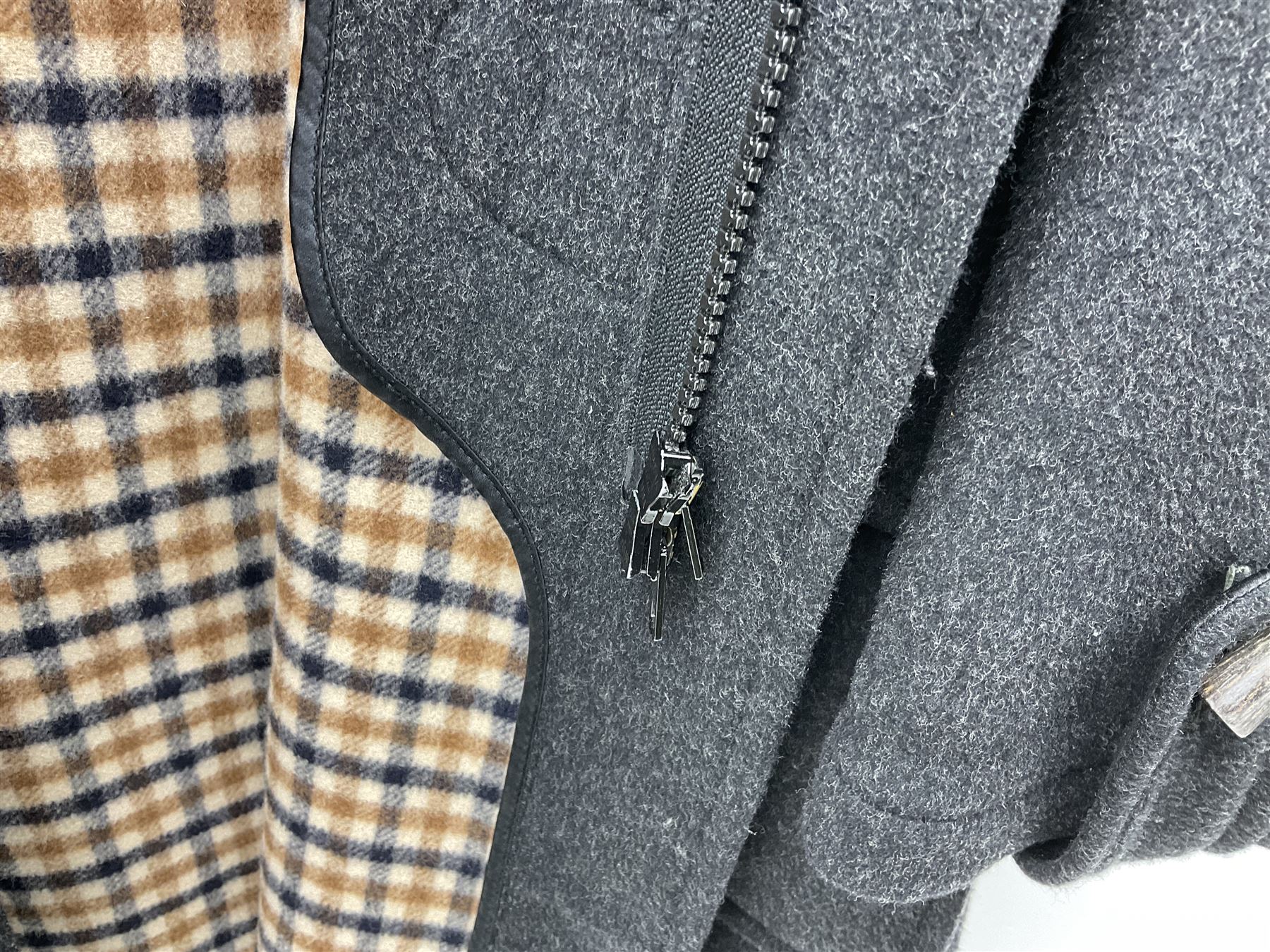 Men's Aquascutum lambs wool herringbone tweed coat with silk lining, 46 Reg, together with a further Men's Aquascutum grey wool duffle coat, with cheque lining and horn buttons, 46