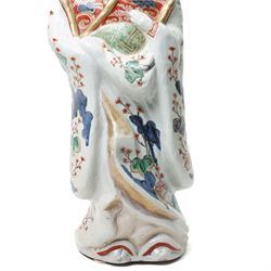 Large Japanese Imari porcelain figure, modelled as a Bijin, wearing a long kimono decorated with apple blossom and leafy branches on a white ground, with gilt detailing, possibly Edo period, H63cm