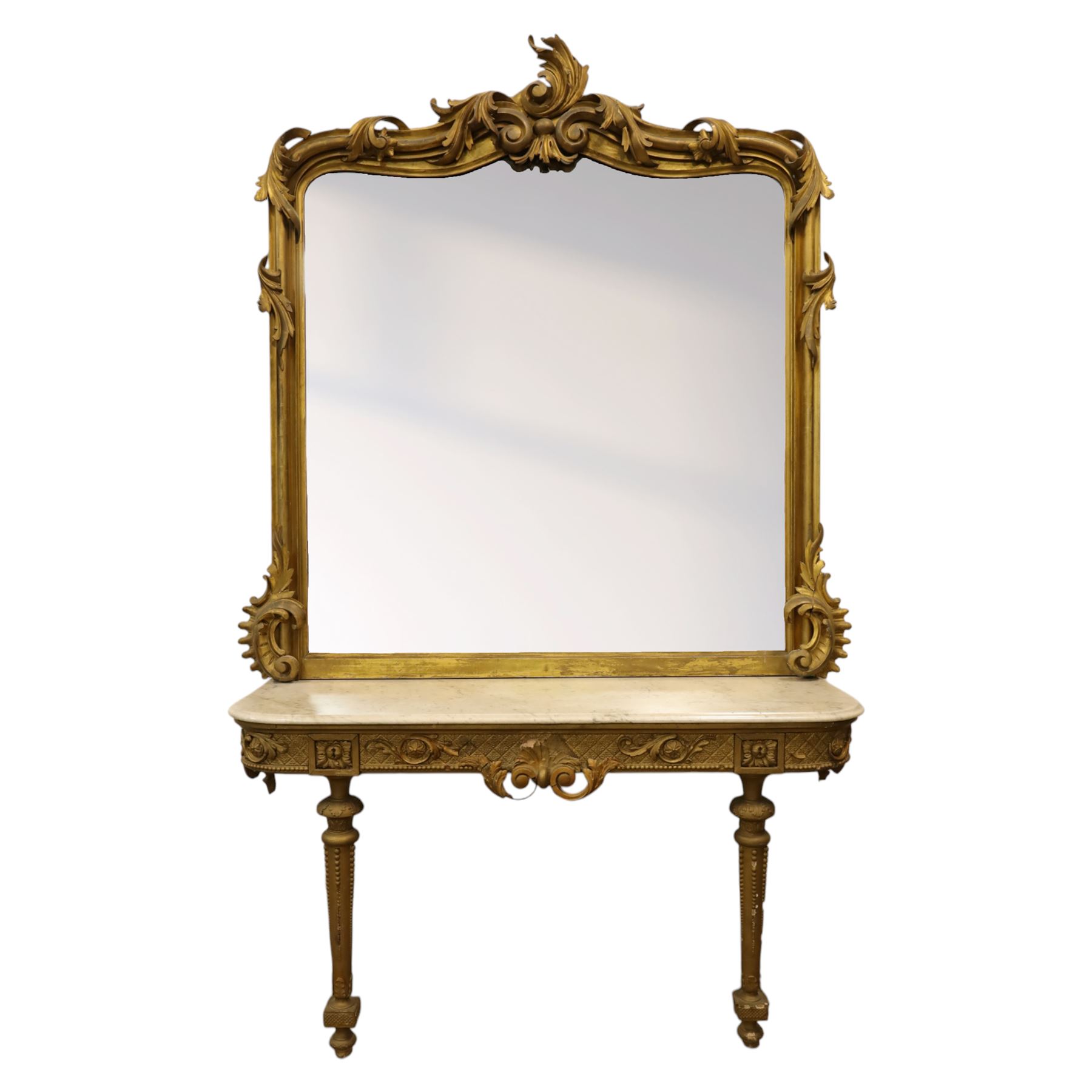 Large late 19th century Rococo revival giltwood and gesso pier mirror, the rounded rectangular frame with richly carved crest and scrolls with acanthus leaves and foliate ornamentation, above a giltwood console table with Carrara marble top and richly carved guilloche and ribbon tied laurel garland frieze, rosettes, and central scrollwork, raised upon tapered legs with beaded moulding and square block above with turned toupie style terminal  