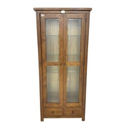 Stained oak display cabinet, fitted with two glazed doors with bevelled plates, over two drawers