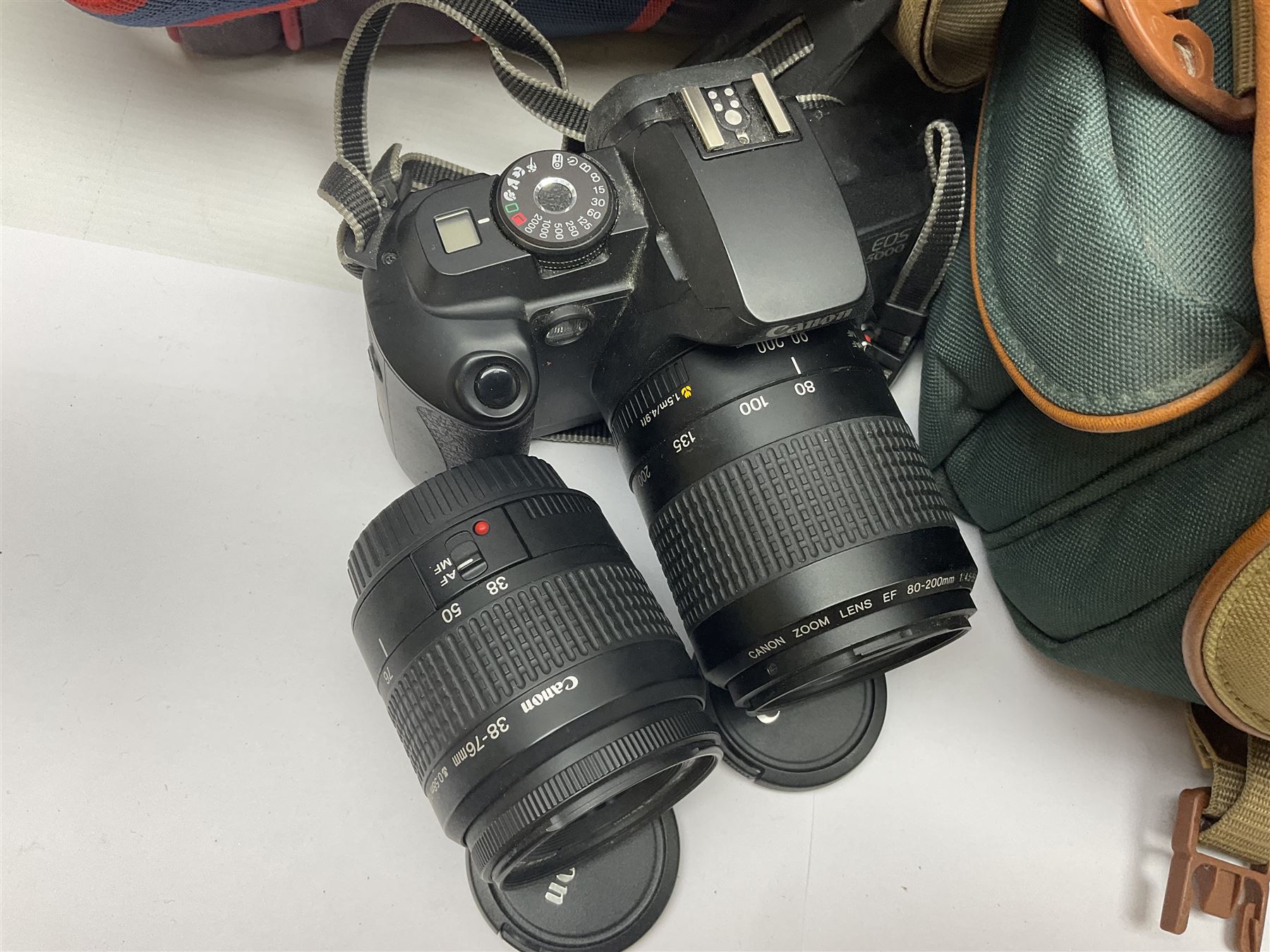 Cameras and accessories, to include Olympus OM101 Power Focus camera body, serial no 1076067, with 'Sigma AF Zoom 1:38, f=75 200mm' lens, serial no 2053714, Canon EOS 5000 camera body, serial no 1507812, with 'Canon Zoom EF 80-200mm, 1:4.5-5.6' lens, other cameras, by Miranda, Coronet and Ricoh and a collection of lenses, carry cases, etc 