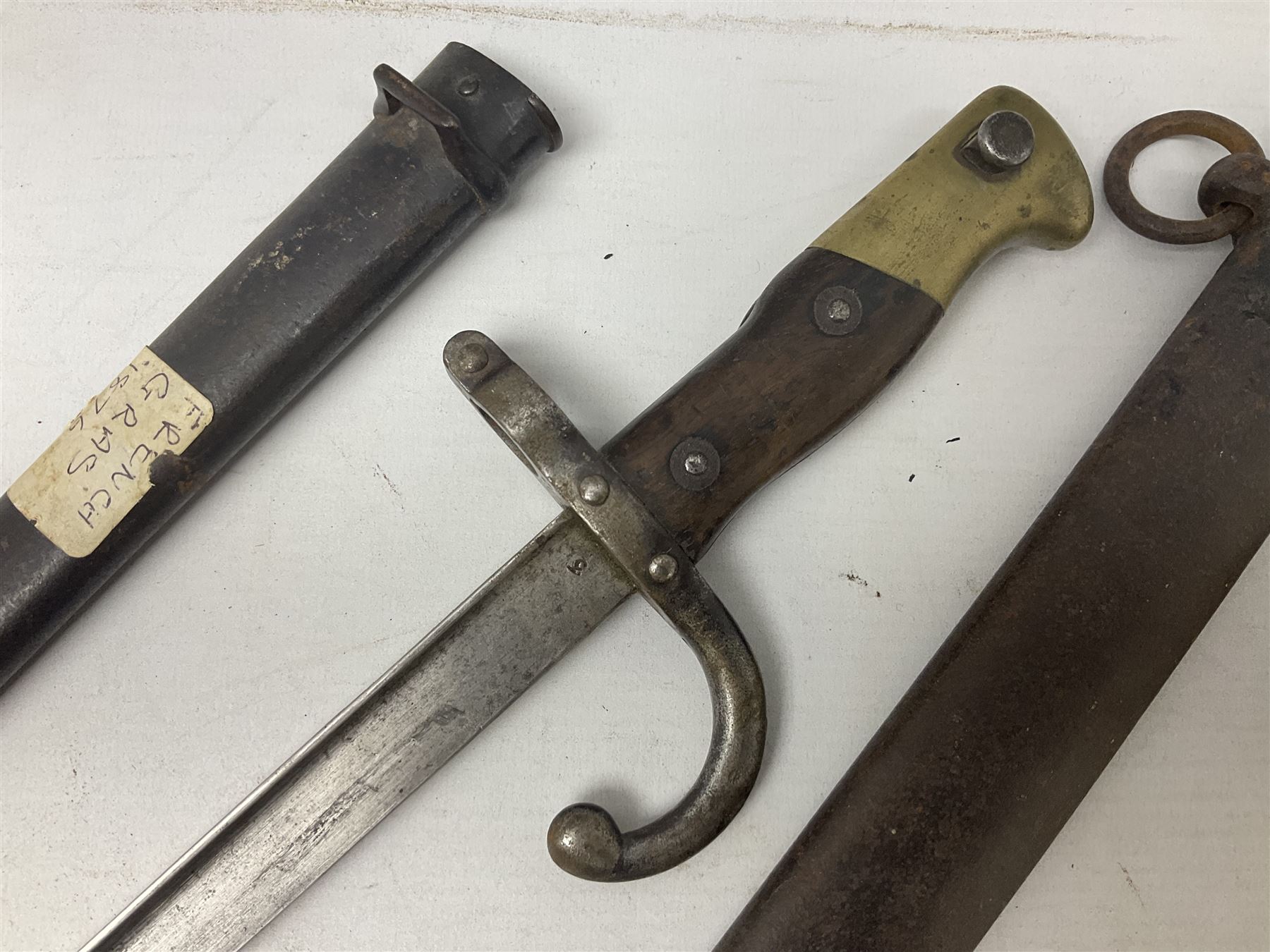 French Model 1874 Epee bayonet marked Oulle 1876 in associated scabbard; Model 1866 sabre bayonet in cut-down sword scabbard; and Model 1842/59 sabre bayonet in relic condition (3)