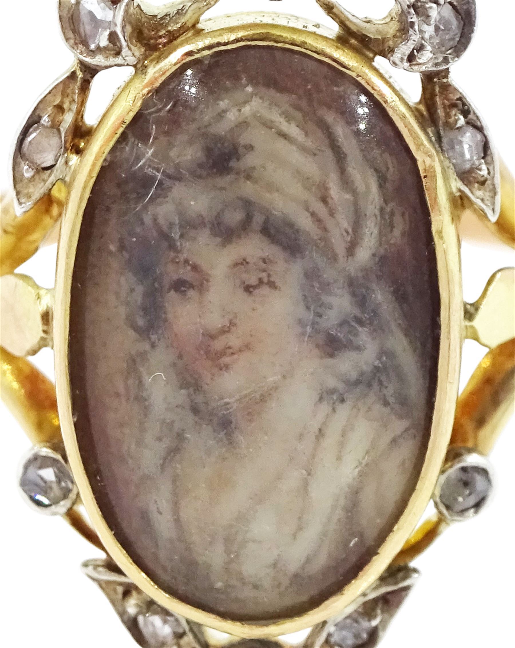 19th century gold and silver diamond portrait ring, set with an oval miniature of a woman on ivory, under a glazed panel, with rose cut diamond bow and floral sprigs below, to trifuricated shoulders. This lot has been registered for sale under Section 10 of the APHA Ivory Act