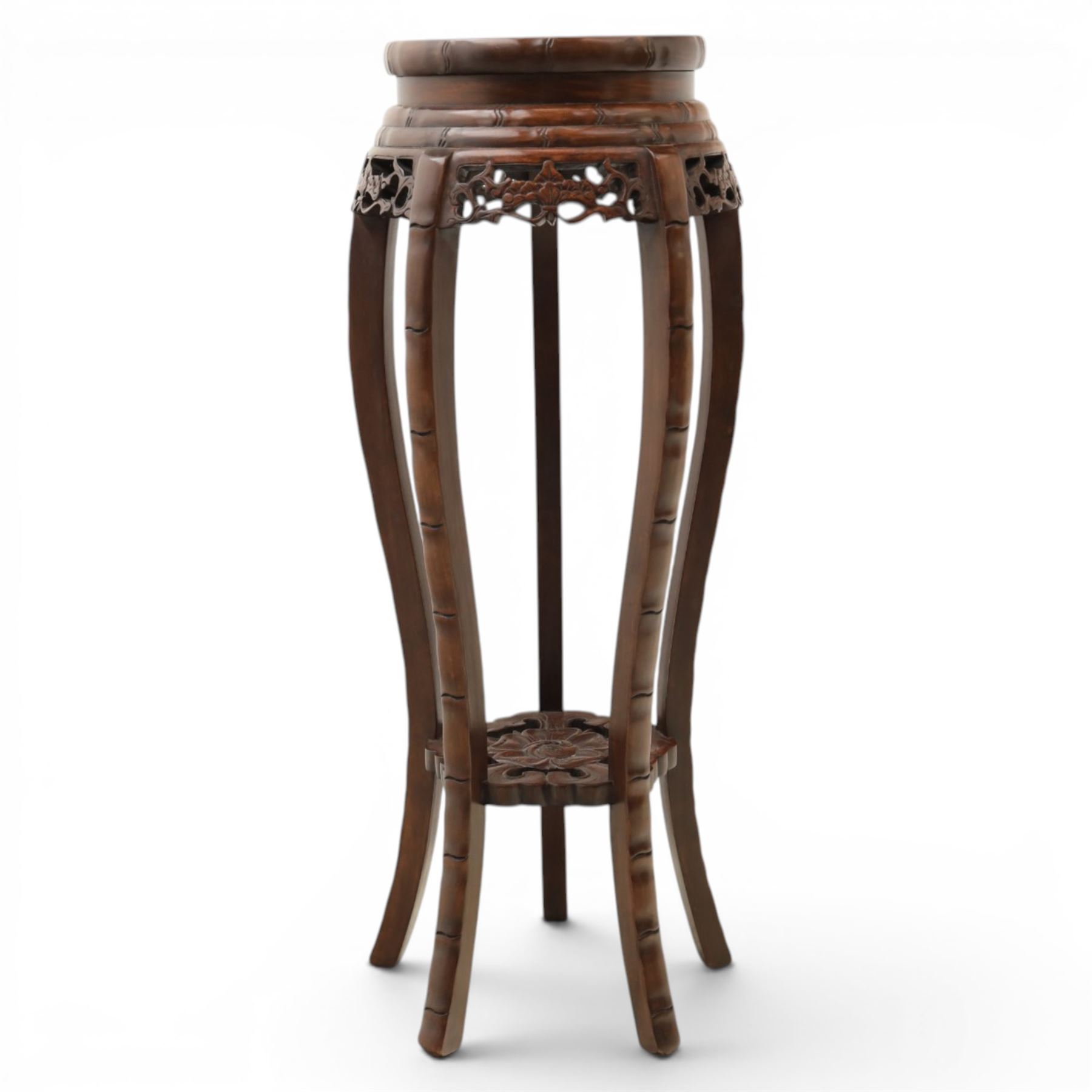 Chinese hardwood jardiniere stand, with inset black veined white marble, pierced carved apron united by rose carved undertier