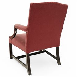 Georgian design mahogany Gainsborough chair, upholstered in pink fabric, curved and moulded arm supports, on moulded square front supports united by H-stretchers 