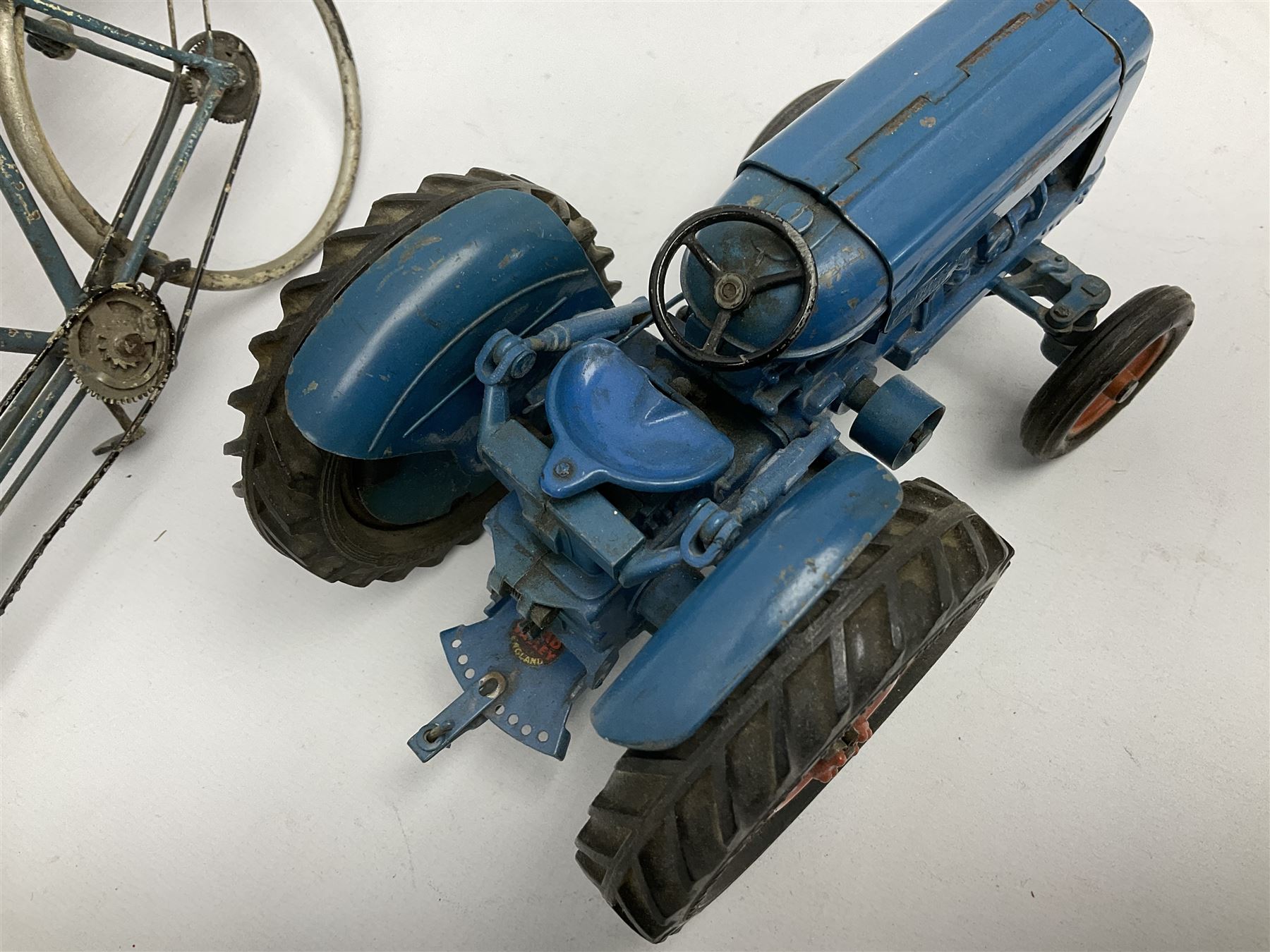 Chad Valley clockwork Fordson Major Tractor, a group of play worn Britains and other lead and metal farm animals, figures and accessories including a kennel, haystacks, dovecote, cows, sheep etc, together with a diecast model of a Tandem Bike L31cm