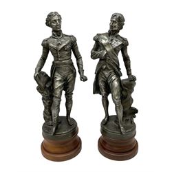 After S. Kinsburger, pair of early 20th century polished spelter figures of Lord Nelson and Arthur Wellesley, each depicted wearing full uniform and standing beside a rock; inscribed S. Kinsburger H39cm; on later turned mahogany bases H47cm overall (2)