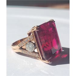 Rose gold rubellite tourmaline and diamond ring, the central octagonal step cut tourmaline of 43.25 carat, with a round brilliant cut diamond set either side and diamond set shoulders by Judith Crowe, hallmarked 9ct, the two large side diamonds total 2.10 carat, with World Gemological Institute report