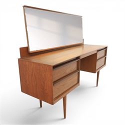 Austinsuite - mid 20th century teak headboard with bedside cabinets and matching  mirrored dressing table, the headboard with floating single drawer bedsides raised on a single tapering support, the dressing table with attached tilting mirror, above rectangular top with kneehole and two banks of two drawers, raised on tapering supports

Headboard H 84cm, D 40cm, W 229cm, W between bedsides 151cm 
Dressing table H 113cm D 44cm, W 149cm, H to underside of dresser 61cm