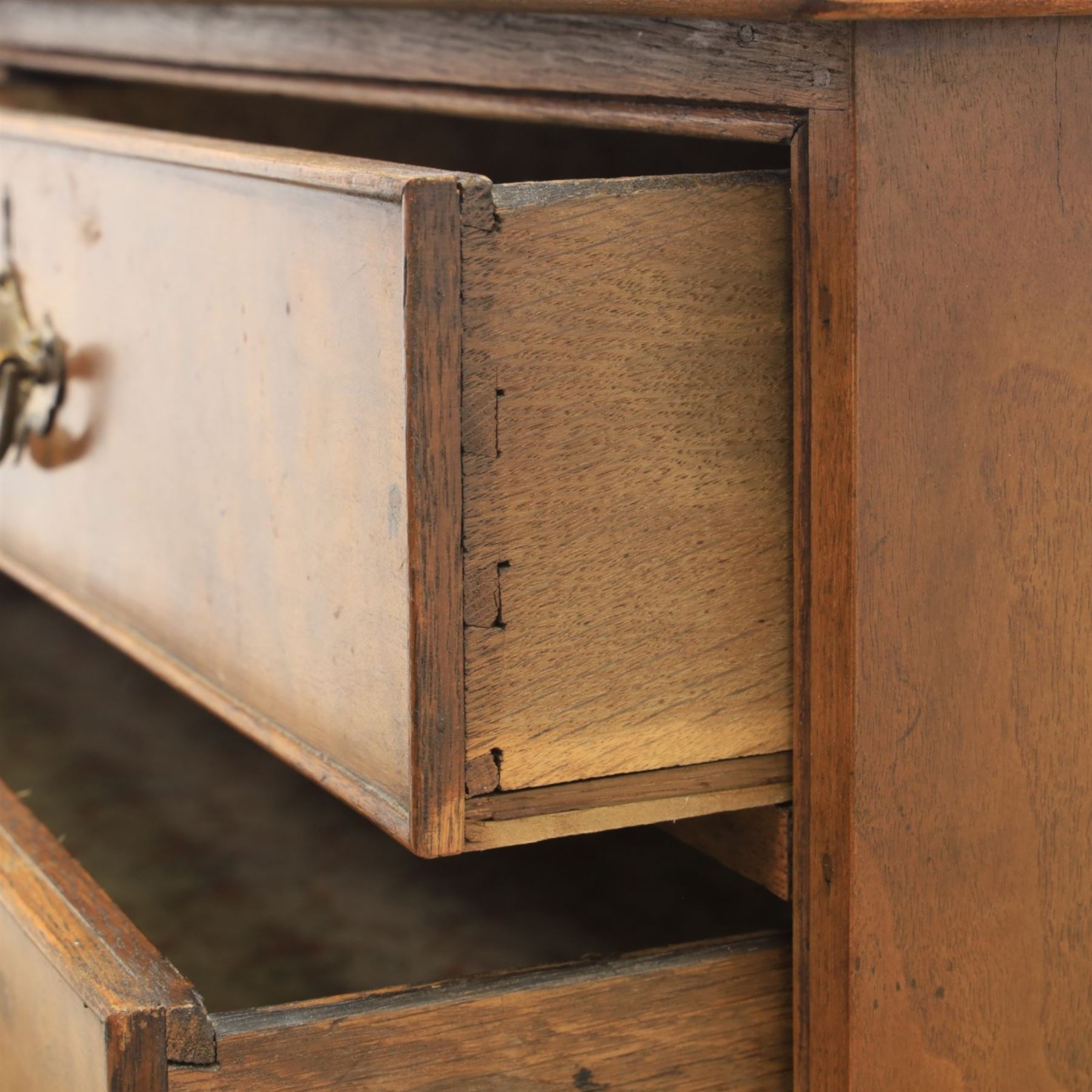 Traditional design walnut inlaid chest, with figured top with circular inlay and crossbanded top with moulded edge, figured drawers with cockbeaded edges and brass handles, raised on bracket feet