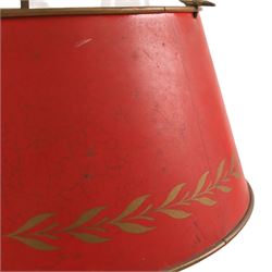 Bouillotte lamp, the adjustable red tole shade above three brass sconces upon a circular dished base, H54cm