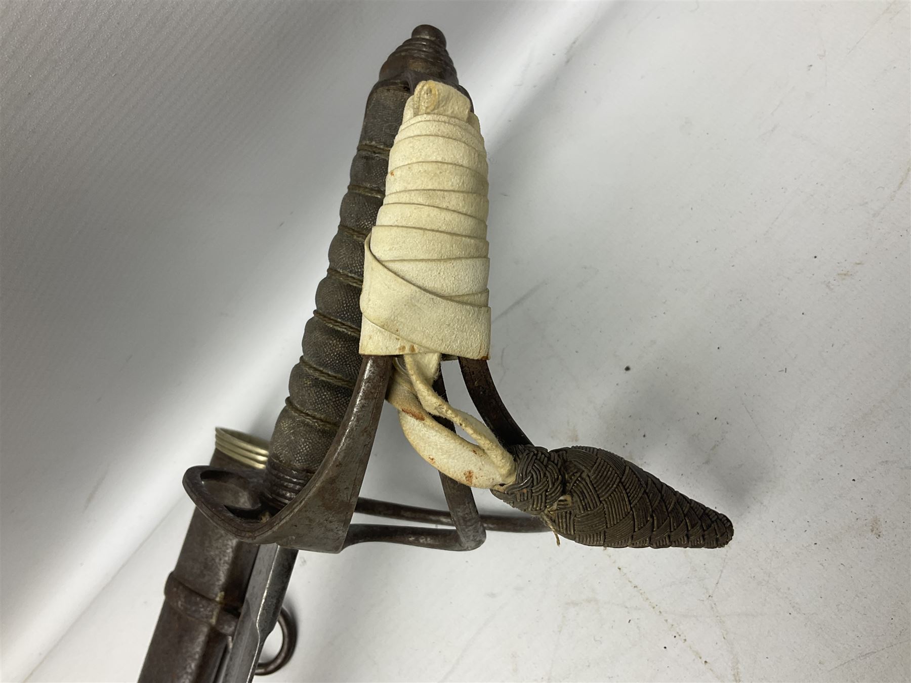 British 1821 Pattern Light Cavalry Officer's sword, with plain 87.5cm slightly curving fullered steel blade and plain steel three-bar hilt with wire-bound fish skin grip and plaited knot on later cord; in steel scabbard with two hanging rings L103cm overall
