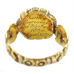 Georgian gold emerald and pearl mourning ring, the glazed central panel containing locket of hair, with emerald and split pearl surround, the shoulders and shank with foliate decoration, the underside of the head inscribed 'James Newcomb died 24 Jan 1820 aged 53 ys'