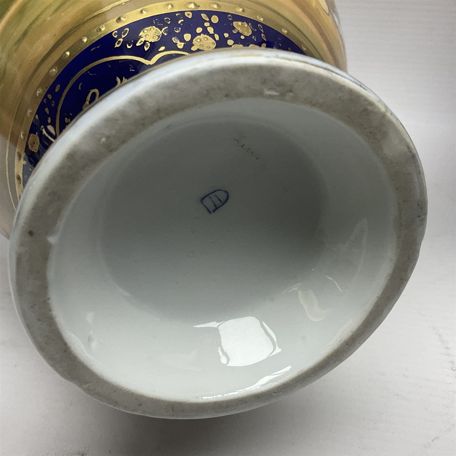 19th century Vienna style porcelain 'Musik' garniture, the central vase of baluster form with domed cover flanked by two smaller vases with twin curved gilt handles to short neck, each decorated with classical figural vignettes between blue borders heightened with gilt, H33.5cm