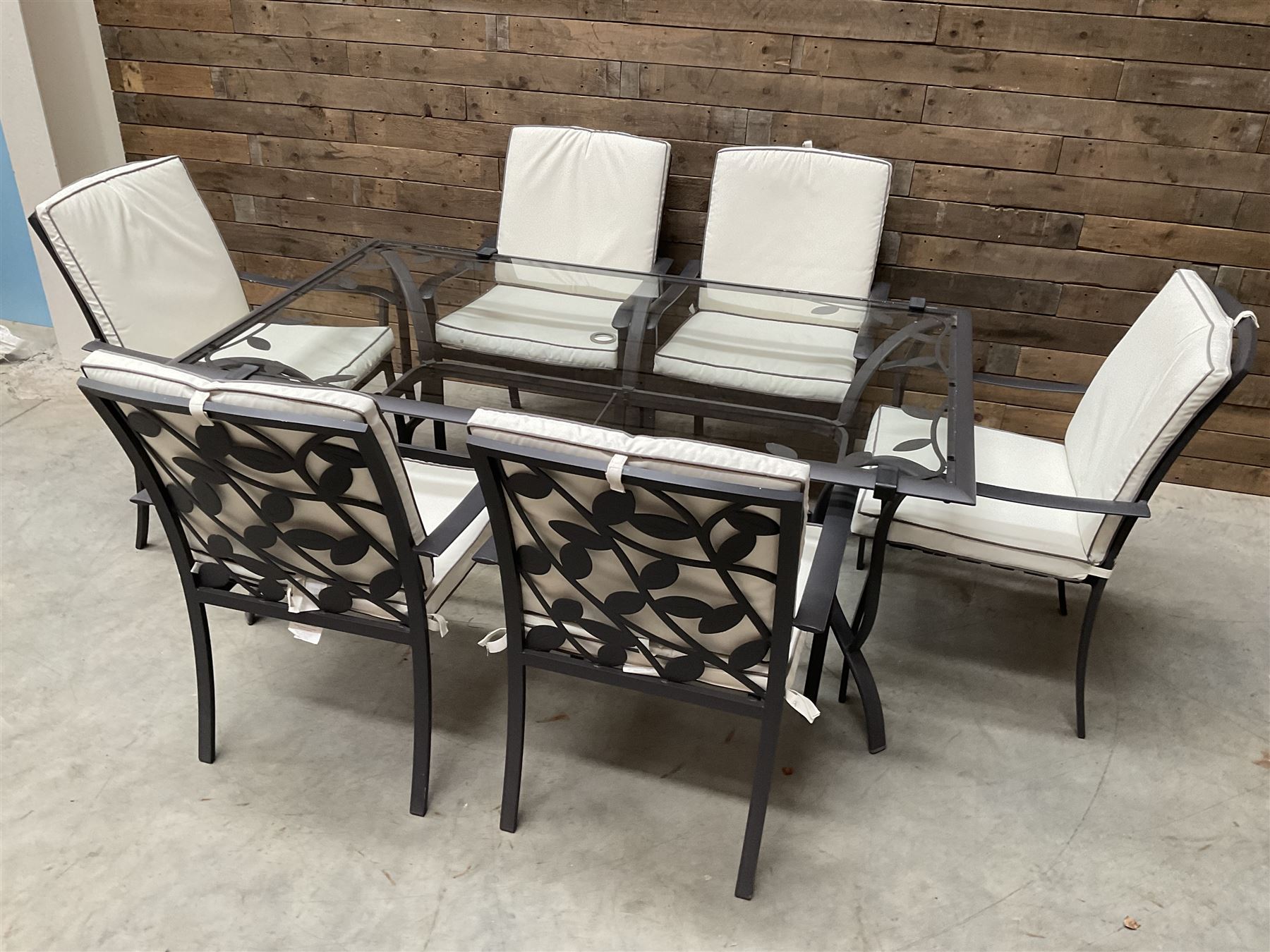 Metal framed garden table with glazed top (W170cm, D102cm, H71cm) and six armchairs with cushions 