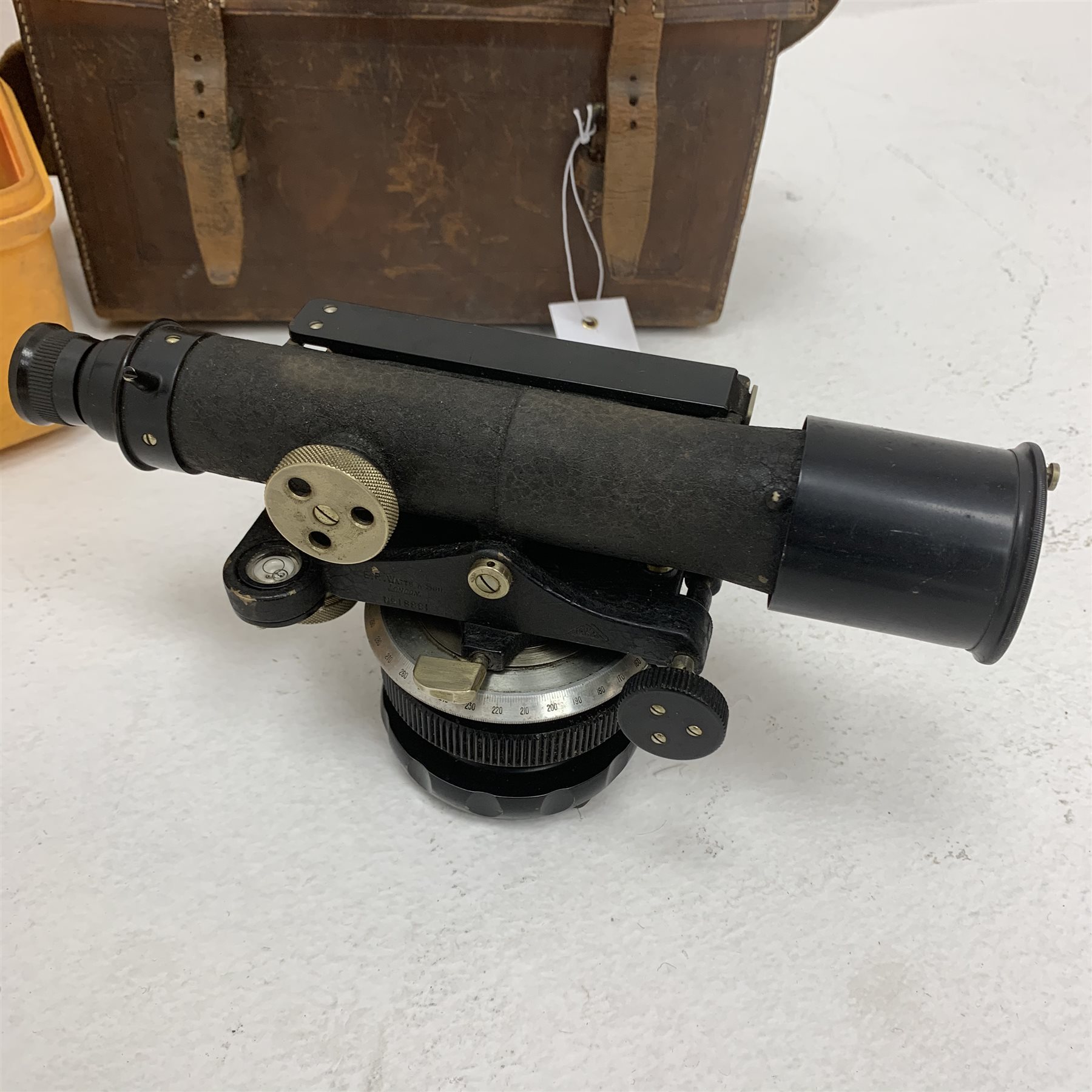 Carl Zeiss Theo 015B orange painted theodolite serial no.251267 in fitted case with accessories; E.R. Watts & Sons London level with black crackled body, serial no.1888, in calf leather carrying case; wooden folding tripod and telescopic measuring staff (4)