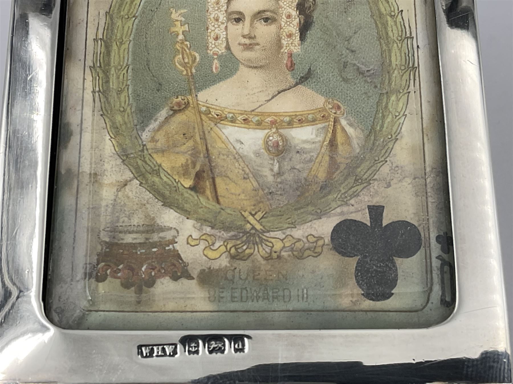 Edwardian silver mounted playing card case, hallmarked William Harrison Walter, Birmingham 1903, the sides each with a period playing card set behind a bevelled glass panel, the hinged cover with later engraving 'Presented to Norman T Crombie Esq by the officers & men of the 31st WR Detachment for services rendered 1917-1918', with red leather lined interior, the three compartments upon a sprung base and containing two later wooden Whist markers, case H12.5cm