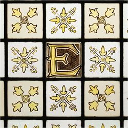 Edwardian stained glass panel, with central painted E motif surrounded by flowers and Yorkshire roses, H47cm