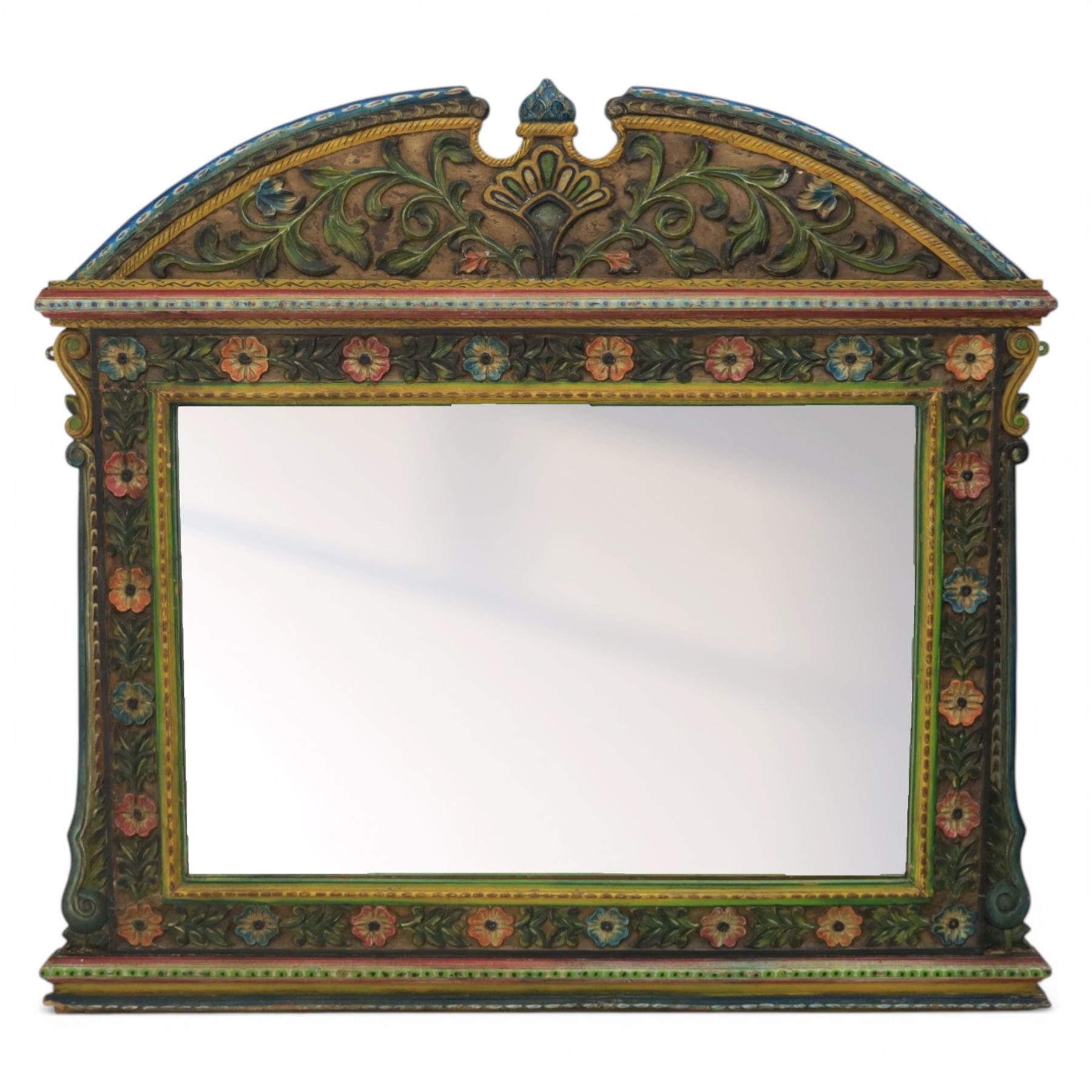 Late 20th century Venetian style polychrome carved wall mirror, arched cresting with central shell motif and scrolling foliate decoration, moulded frame with carved floral borders in relief, enclosing rectangular mirror plate, shaped sides with scroll terminals