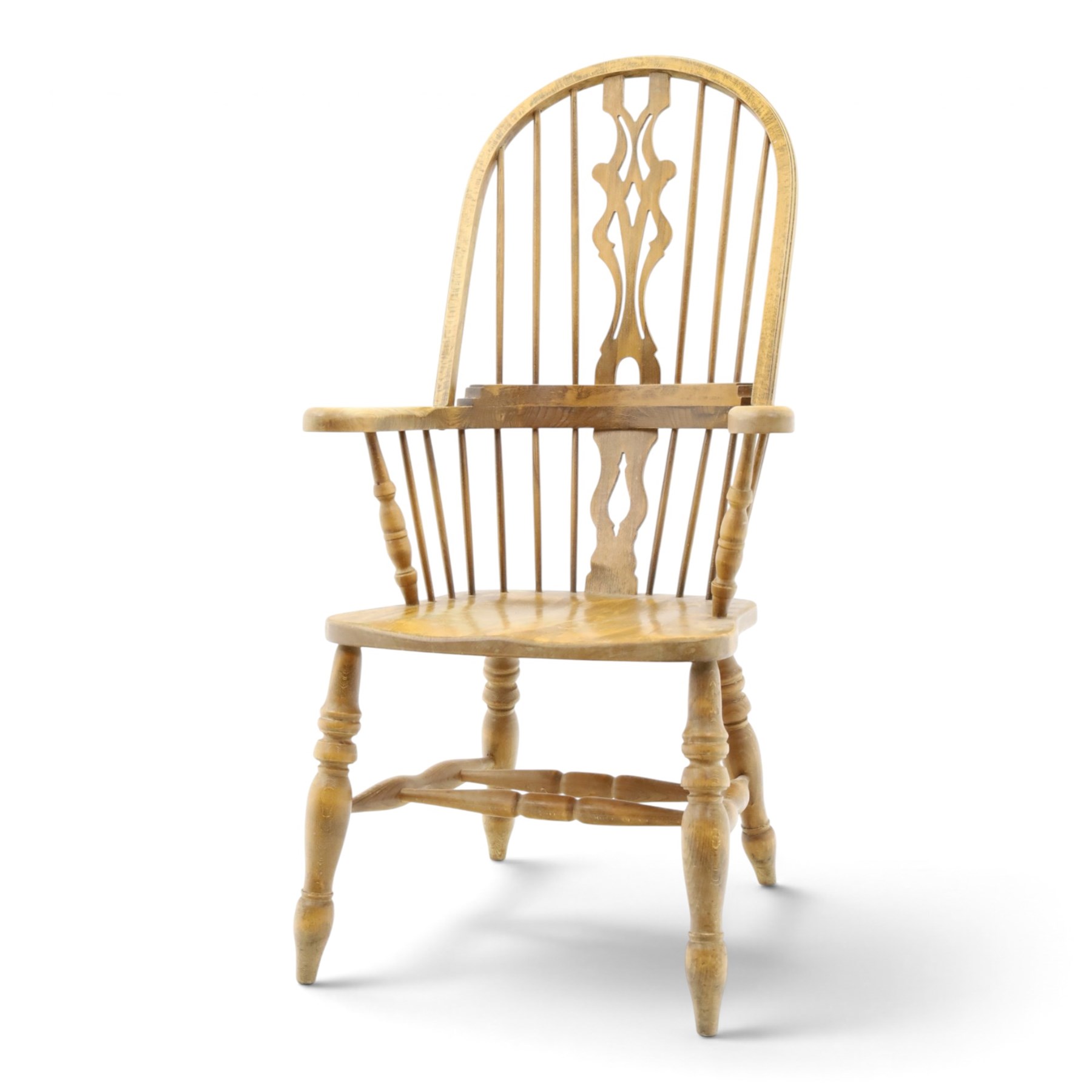 Traditional elm Windsor armchair, hooped spindle back with pierced splat, shaped elm seat, on turned supports united by double H stretcher, turned supports