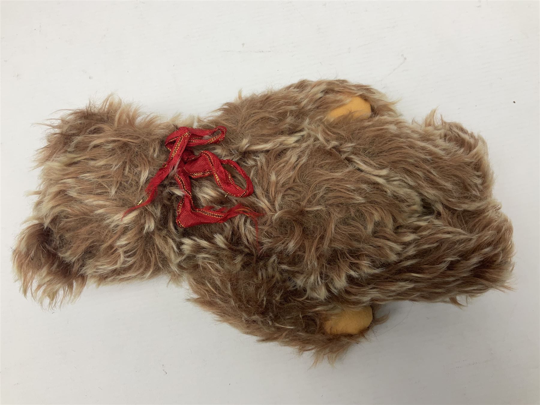 Steiff teddy bear with golden plush body, revolving head, applied eyes, vertically stitched nose and mouth and jointed limbs; button to left ear H26cm; and two other Steiff teddy bears, each with open mouth and button with tag to left ear (3)
