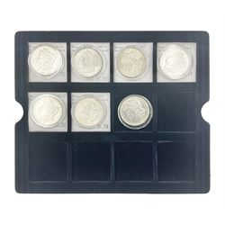 Seven United States of America silver Morgan dollar coins, dated 1884, 1901 O, 1902 O, 1903, 1904 O, 1921 D and 1921