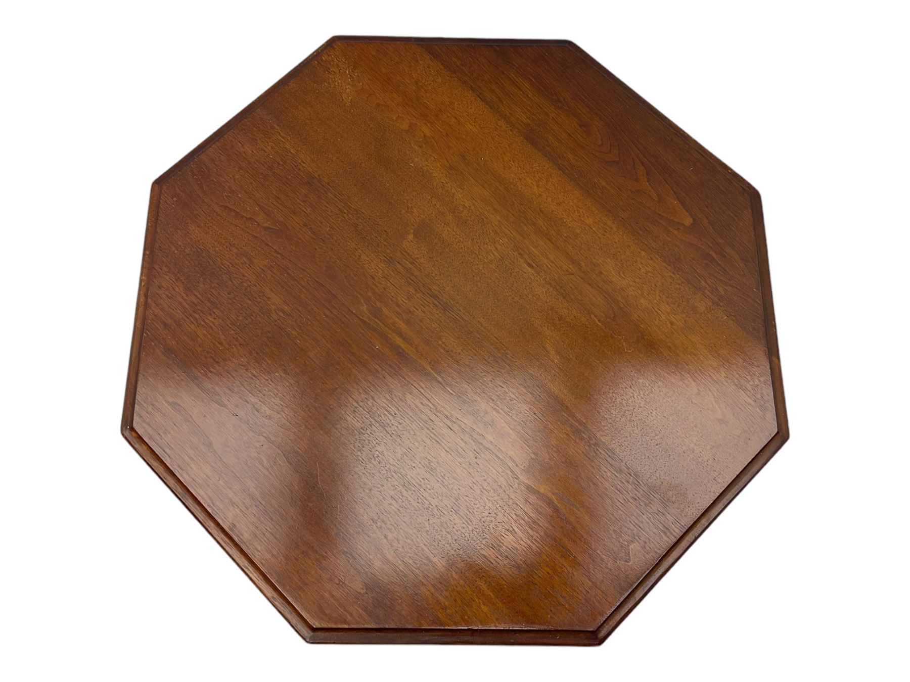 Victorian oak occasional table, octagonal top with bevelled edges, lower section fitted with a square undertier united by decorative shaped stretchers, on turned supports with castors