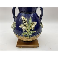 Minton majolica vase, the squat body with twin handles, with part osier moulding and applied Spring flowers against a cobalt blue ground, upon integral square base, impressed beneath Minton 1316, H16.5cm