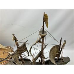 Wooden model of an exploration era ship, with three masts, the hull of the caravel painted yellow and with full rigging, together with two wooden model of a sailing boats 