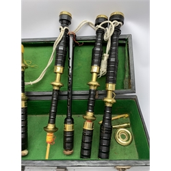  Dummy bagpipes with yellow metal mounted black painted ring turned mahogany drones and Royal Stewart tartan bag, in baize lined carrying case  