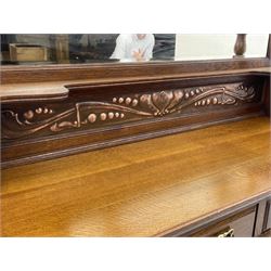 Arts and Crafts period oak mirror back dresser, projecting cornice above rectangular bevelled mirror and shelf, two turned supports, inset copper panel with embossed decoration, rectangular moulded top over two drawers and two panelled cupboard, moulded plinth base, brass and copper strappings and handles 