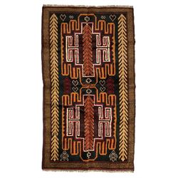 Baluchi dark indigo ground rug, the field decorated with trailing stylised leaf motifs, within a checkered border 