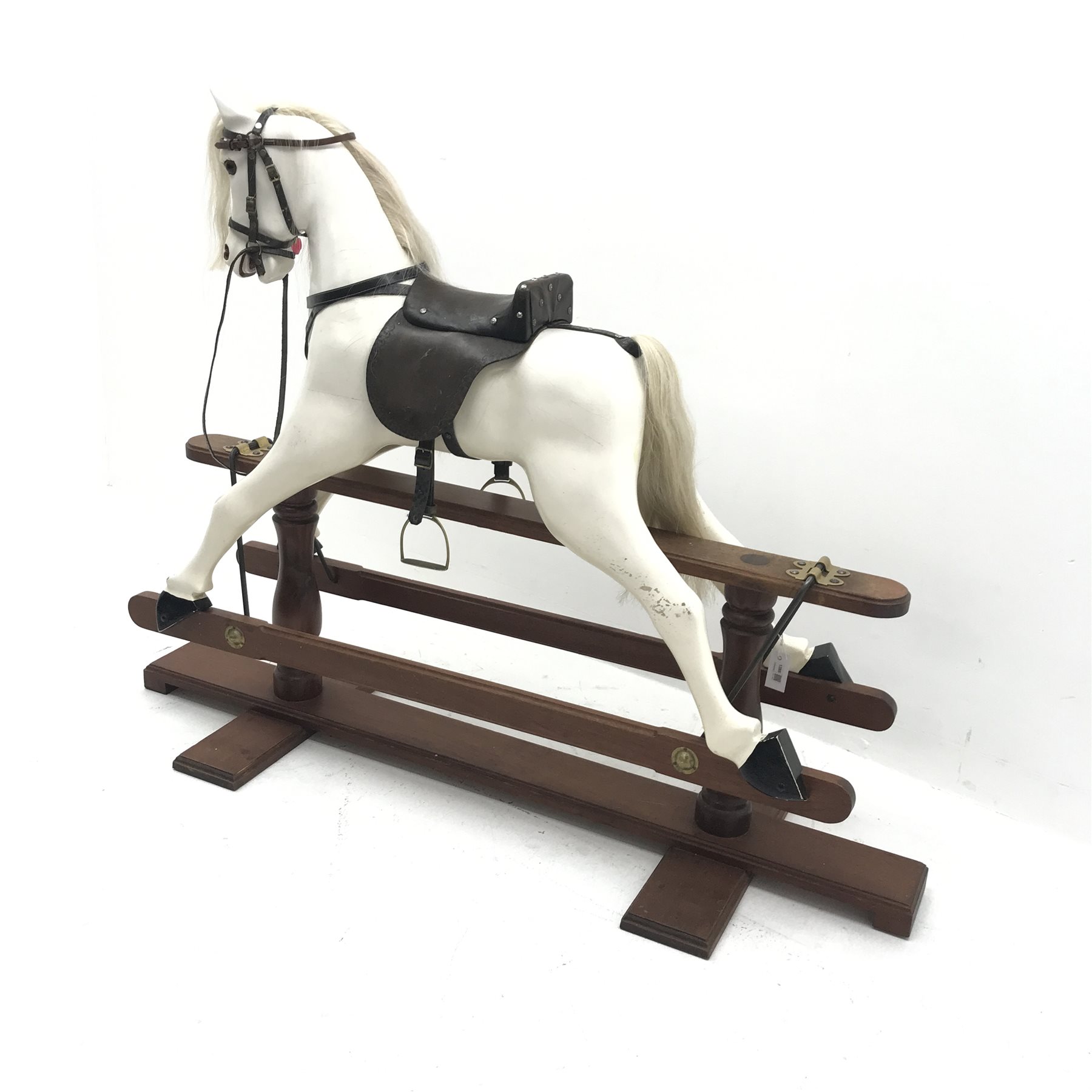 20th century carved and painted wood rocking horse, leather saddle and reins, stirrups, trestle