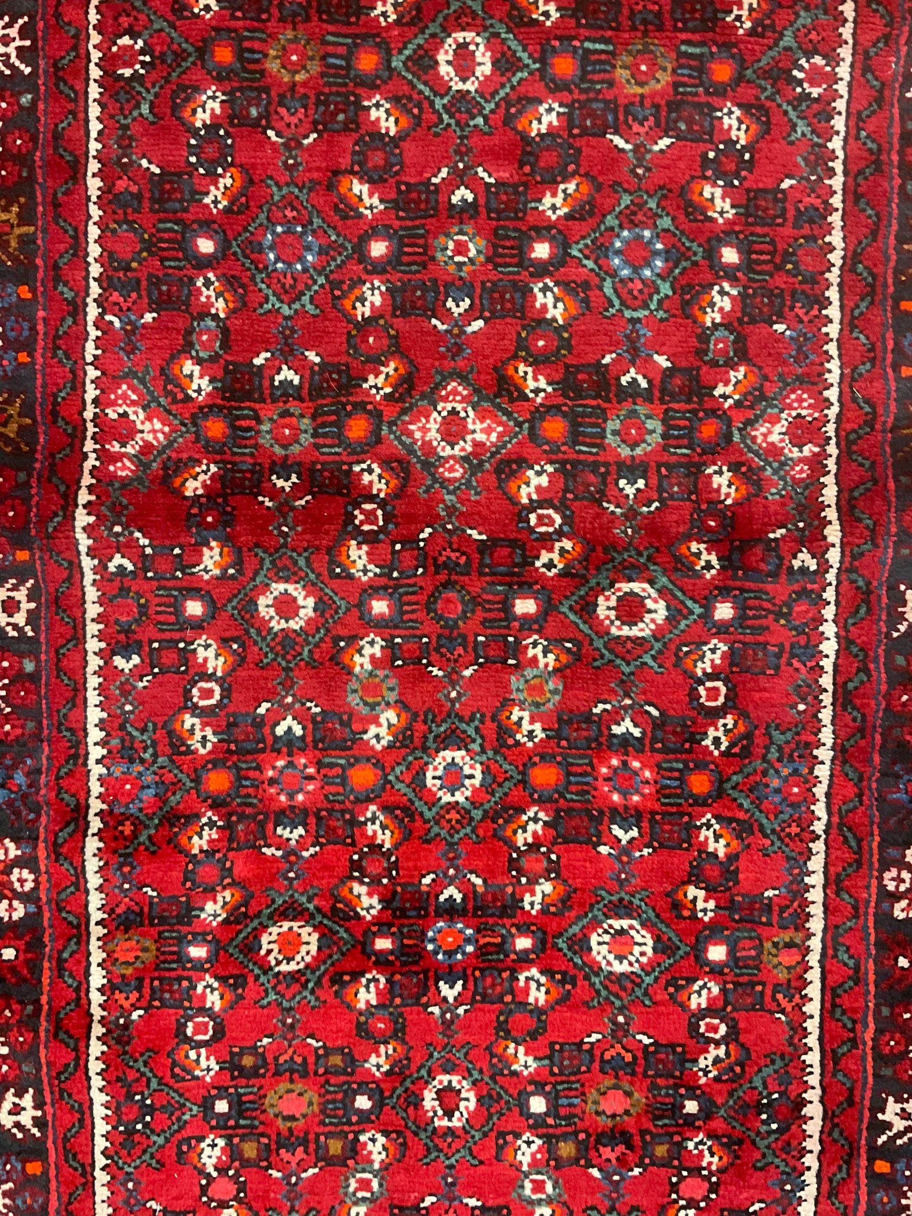North West Persian Malayer runner, red ground field decorated with Herati motifs, guarded border decorated with trailing flowerhead band 