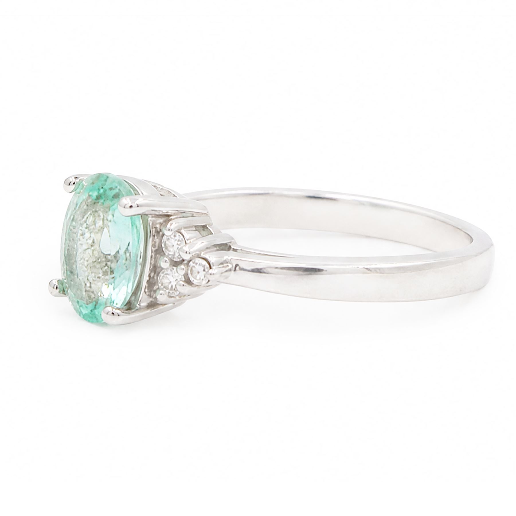 18ct white gold Paraiba tourmaline and diamond ring, single oval cut tourmaline of approx 0.95 carat, with three round brilliant cut diamonds set either side, Birmingham 2008
