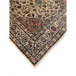 Persian Kashmar camel ground carpet, palmette rosette medallion on a field of curling leafy branches and stylised plant motifs, scrolling border decorated with further palmettes, within floral pattern guard stripes