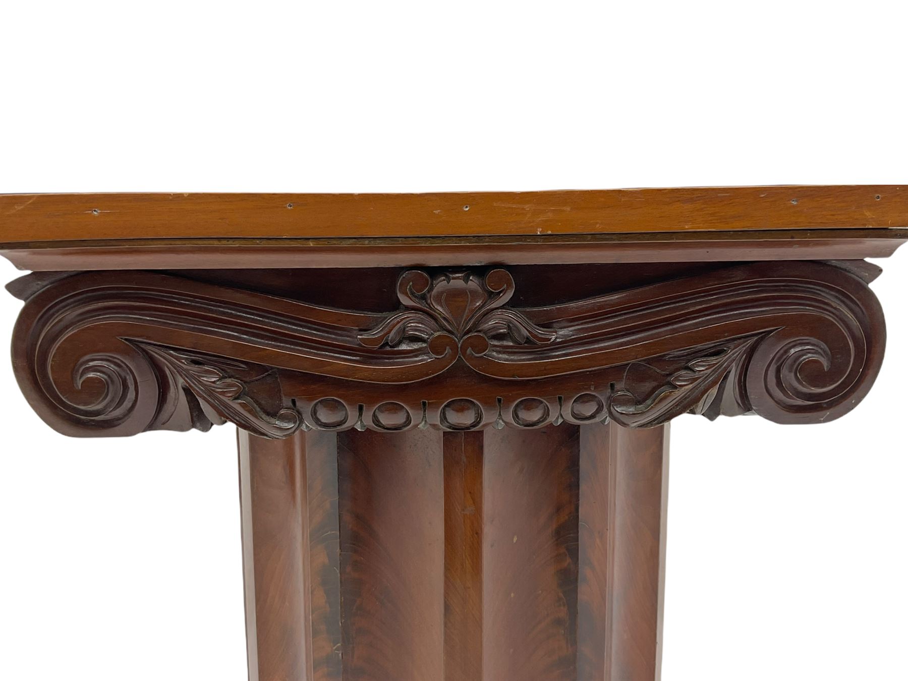 Victorian mahogany vanity unit in the form of a column, the scrolled top with hinged lid revealing mirror, wash bowl and toiletry dishes, on scalloped cylinder pedestal with single door, the interior fitted with shelf
