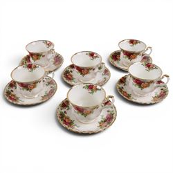 Royal Albert Country Rose tea service for six, comprising teapot, milk jug, covered sucrier, dessert plates, two sandwich plates, cups and saucers 