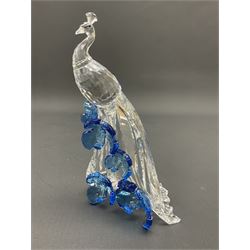 Swarovski Crystal animals, comprising white peacock, the tail with cascading blue flowers, perched eagle with yellow beak, ibex with frosted crystal horns and unicorn with frosted crystal horn, tallest H13cm