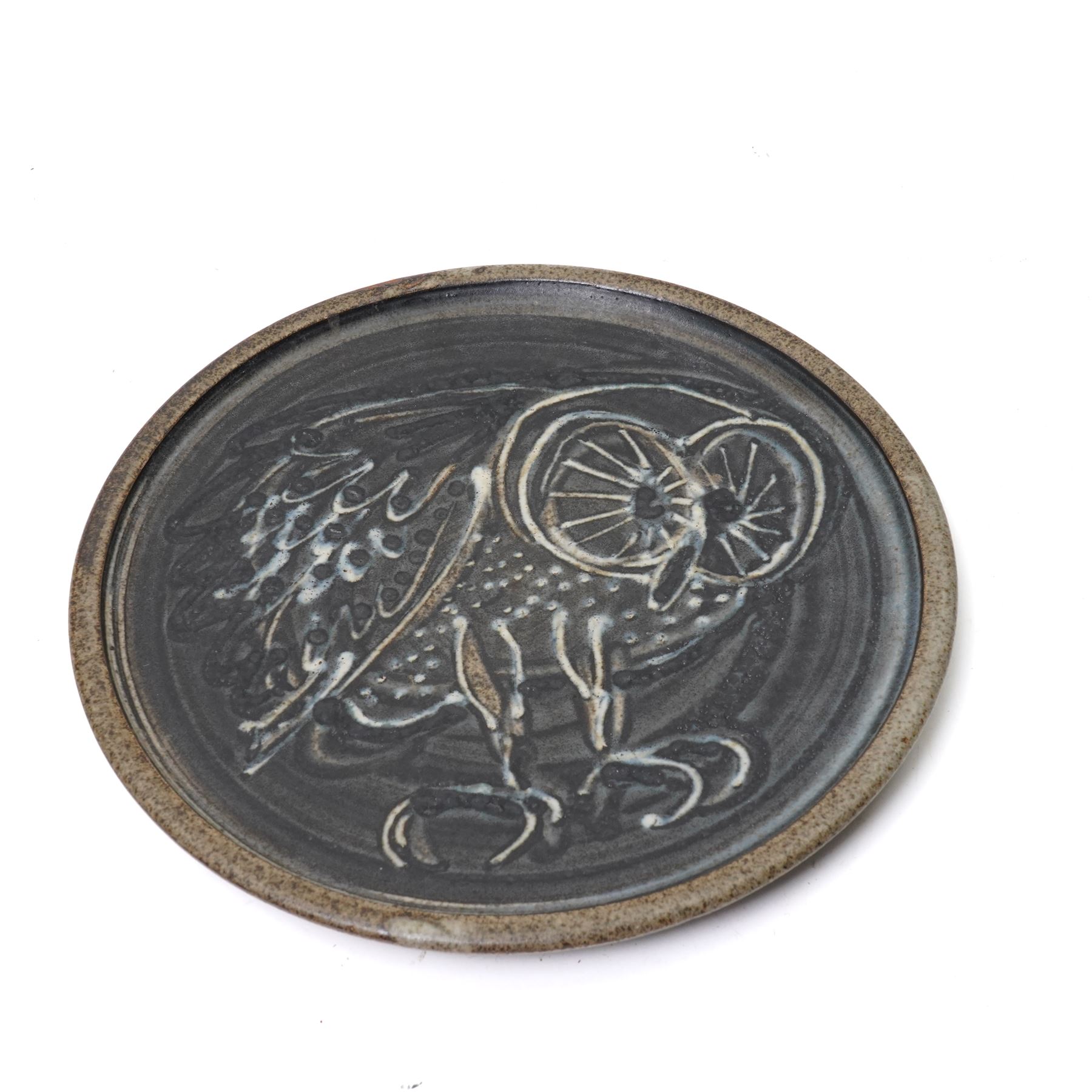 Mick Dixon studio pottery plate, decorate with an owl, impressed marks to base, D27cm; together with slipware dish, impressed BH initials to base, D32cm, a Poole pottery plate and a jug, H25cm (4)