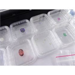 Collection of loose gemstones including tanzanite, fluorite, rubellite, opal, tourmaline, rhodolite garnet, emerald, ruby and amethyst, some with certificates